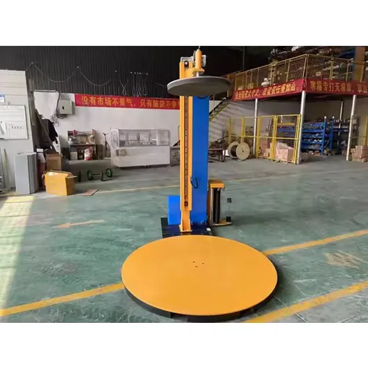 Pallet wrapping machine with top press plate